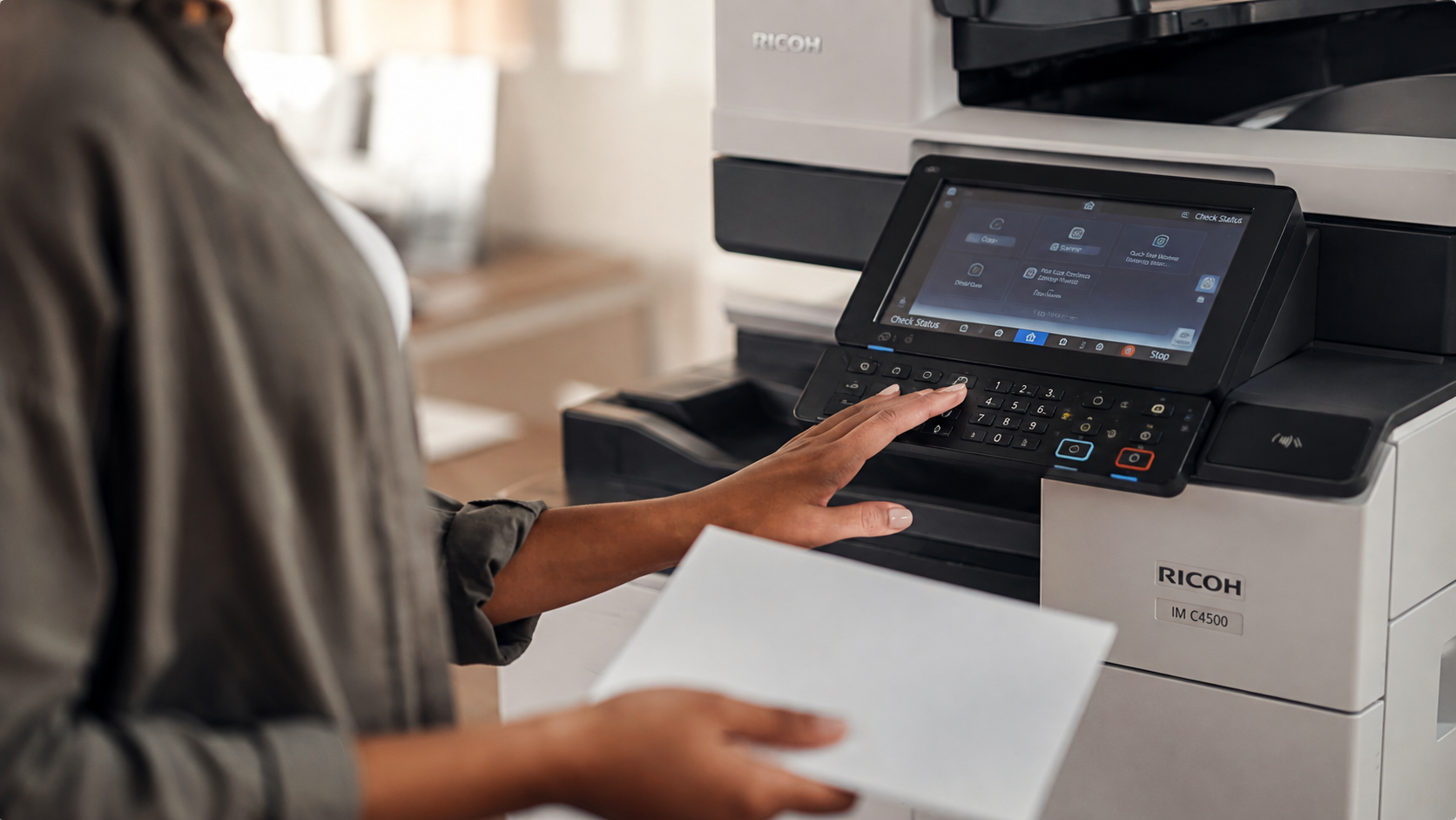 Ricoh Zoom — a person using the touchscreen of a Ricoh IM C4500 multifunction printer in an office.